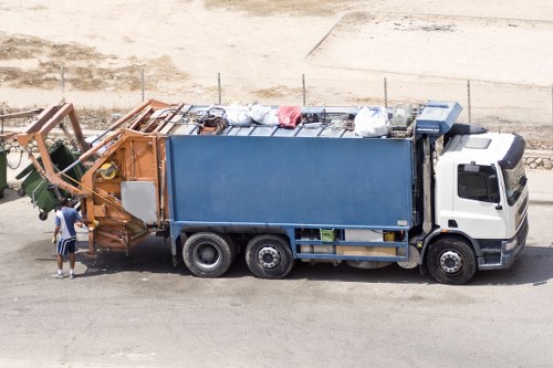 Collection vehicles loading separated recycling at a transfer station