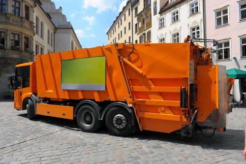Workers handling bins during rubbish collection service
